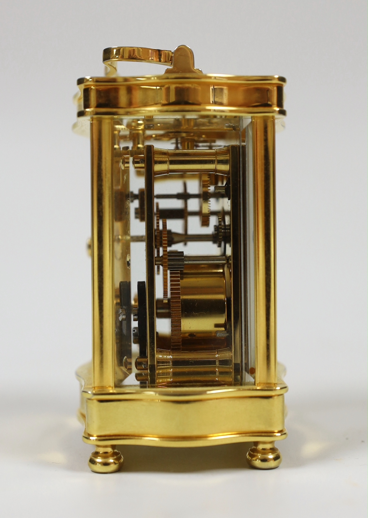 A French miniature brass cased serpentine fronted eight day carriage timepiece by L’Epee, 9cm high
